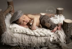 Photo d'un nouveau-né dans un lit en bois par Azemard Stéphanie, photographe spécialisé en naissance et maternité à Vergèze