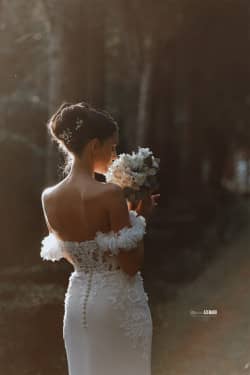 Une mariée élégante portant une robe délicatement ornée, capturée dans un moment de douceur et de lumière naturelle au Domaine du Petit Malherbes, Montpellier. Photographie par Stéphanie Azemard.
